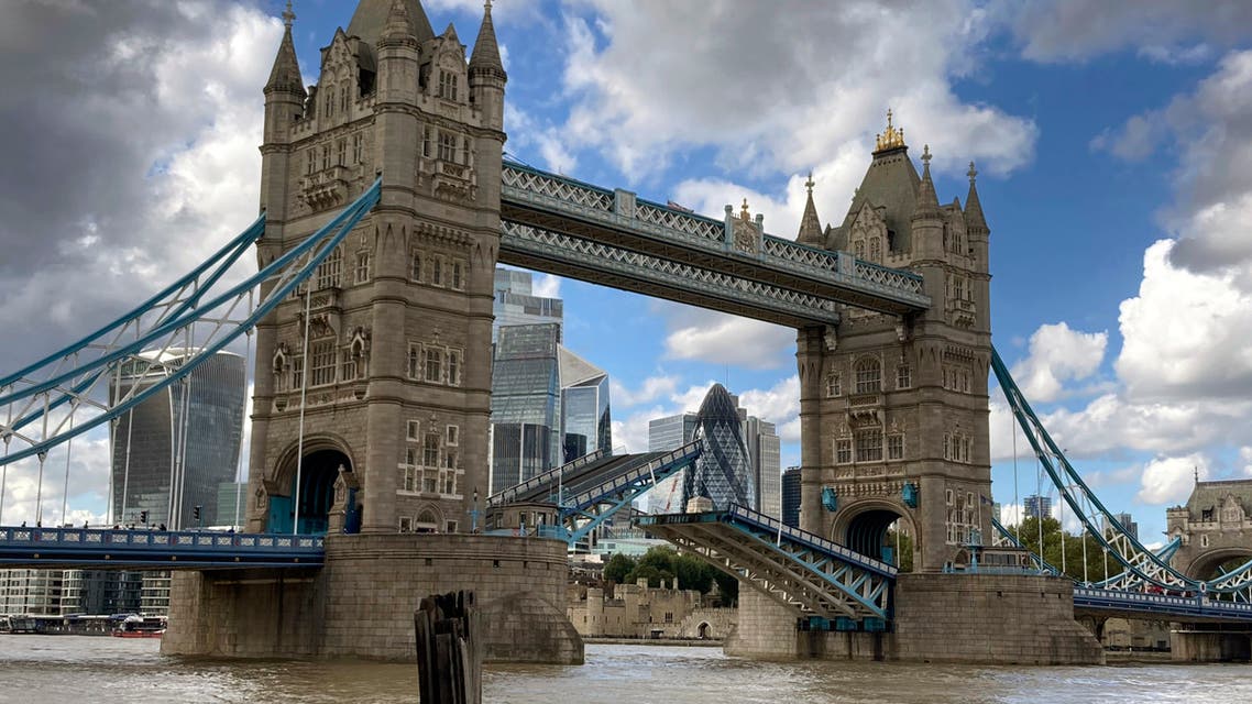 Tower Bridge crossing the River Thames is stuck open, leaving traffic in chaos as the iconic river crossing remains open, in London, Saturday Aug. 22, 2020. The historic bridge has failed to close Saturday after opening to allow ships to pass underneath on the River Thames. The Gherkin building in the financial district of London, front centre left. (AP Photo / Tony Hicks)