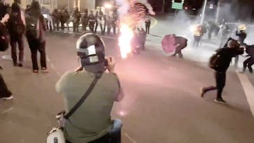 Protesters confront with the police near an Immigration and Customs Enforcement centre in Portland, Oregon, US, on August 20, 2020. (Reuters)