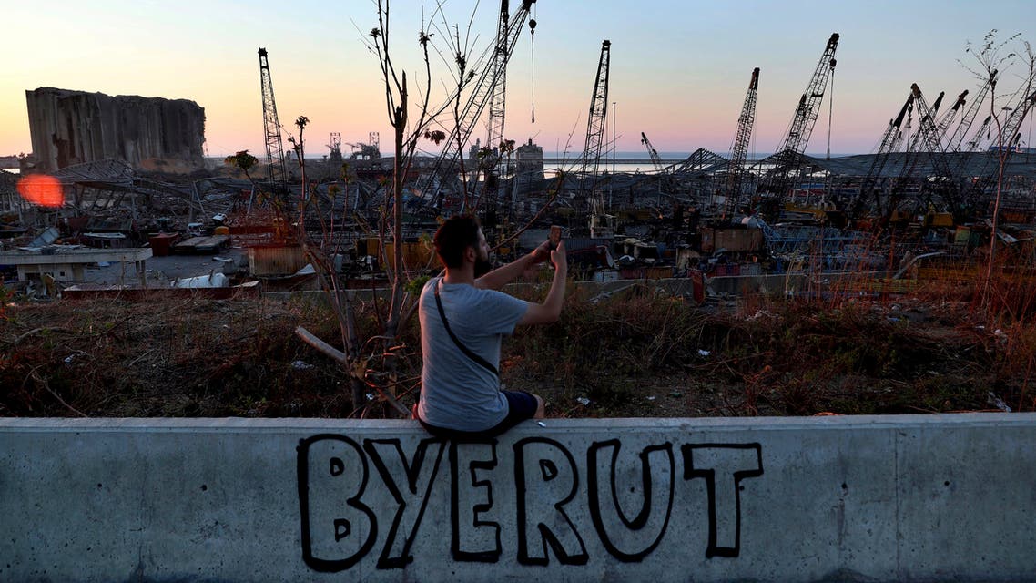 A man uses his phone to take a picture of the site of the Aug. 4 explosion that hit the seaport of Beirut, Lebanon, Sunday, Aug. 16, 2020. (AP)