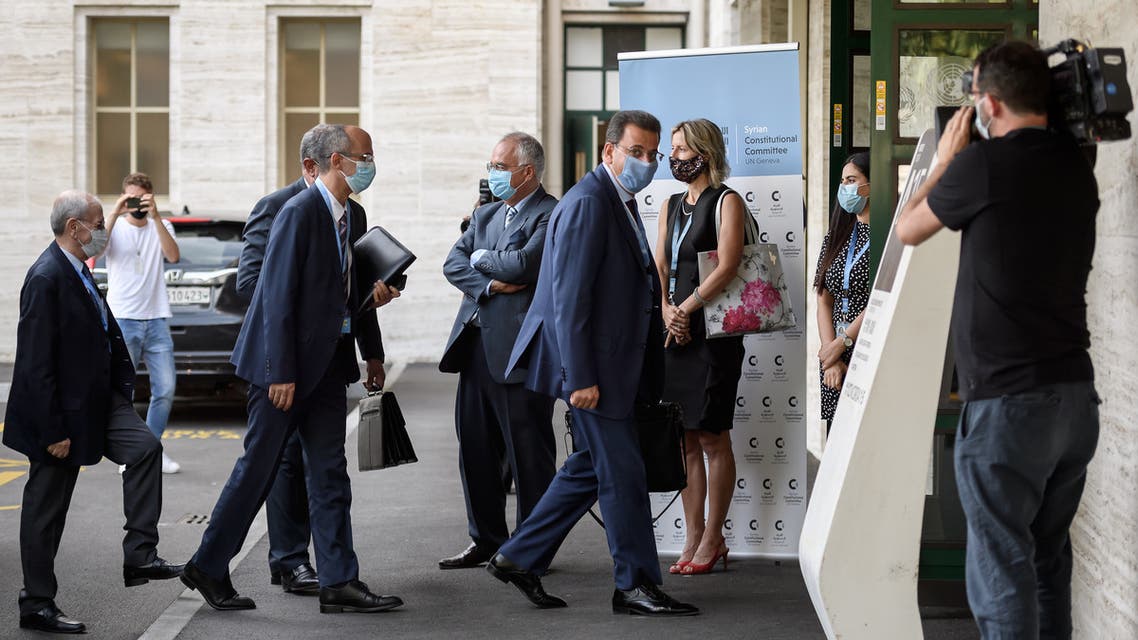 Syrian MP Ahmad Al-Kuzbari (4th R) wearing a protective face mask looks on upon his arrival with the Syrian government delegation for a meeting of Syria Constitutional Committee at the United Nations (UN) Office in Geneva on August 24, 2020. Members of Syria's Constitutional Committee will be meeting for the first time since last November, following delays brought on by the coronavirus crisis.
