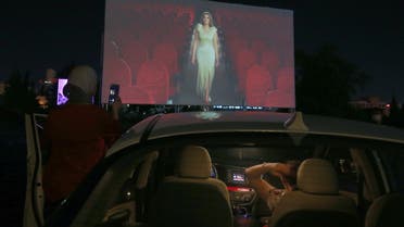 Jordanians sit in their cars at their country's first drive-in cinema, which opened with the French film Les Miserables by Ladj Ly as part of Amman International Film Festival, at a parking lot in New Abdali district in the capital Amman, on August 23, 2020, amid the COVID-19 pandemic. 