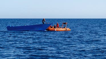A file photo shows members of the Spanish NGO Maydayterraneo rescue a migrant in Mediterranean international waters off the Libyan coast on February 10, 2020. (AFP)