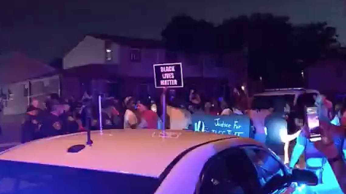 In this image made from video, protesters gather near the site of a police shooting, Sunday, Aug. 23 in Kenosha, Wisconsin. (AP)