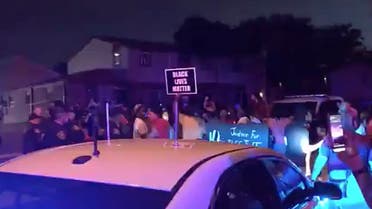 In this image made from video, protesters gather near the site of a police shooting, Sunday, Aug. 23 in Kenosha, Wisconsin. (AP)