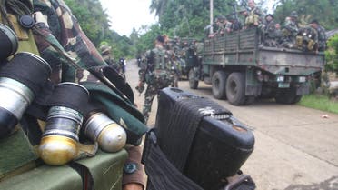 Soldiers gesture aboard a military truck as they are deployed to remote villages in Jolo, Sulu southern Philippines October 17, 2014. (Reuters)