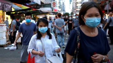FILE PHOTO: Peoaple wear surgical masks at a wet market following the coronavirus disease (COVID-19) outbreak at Sham Shui Po, one of the oldest districts in Hong Kong, China July 17, 2020. REUTERS/Tyrone Siu/File Photo