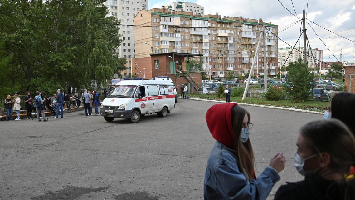People gather outside a hospital, where Russian opposition leader Alexei Navalny receives medical treatment in Omsk, Russia August 21, 2020. Navalny was taken ill with suspected poisoning en route from Tomsk to Moscow on a plane, which made an emergency landing in Omsk. REUTERS/Alexey Malgavko
