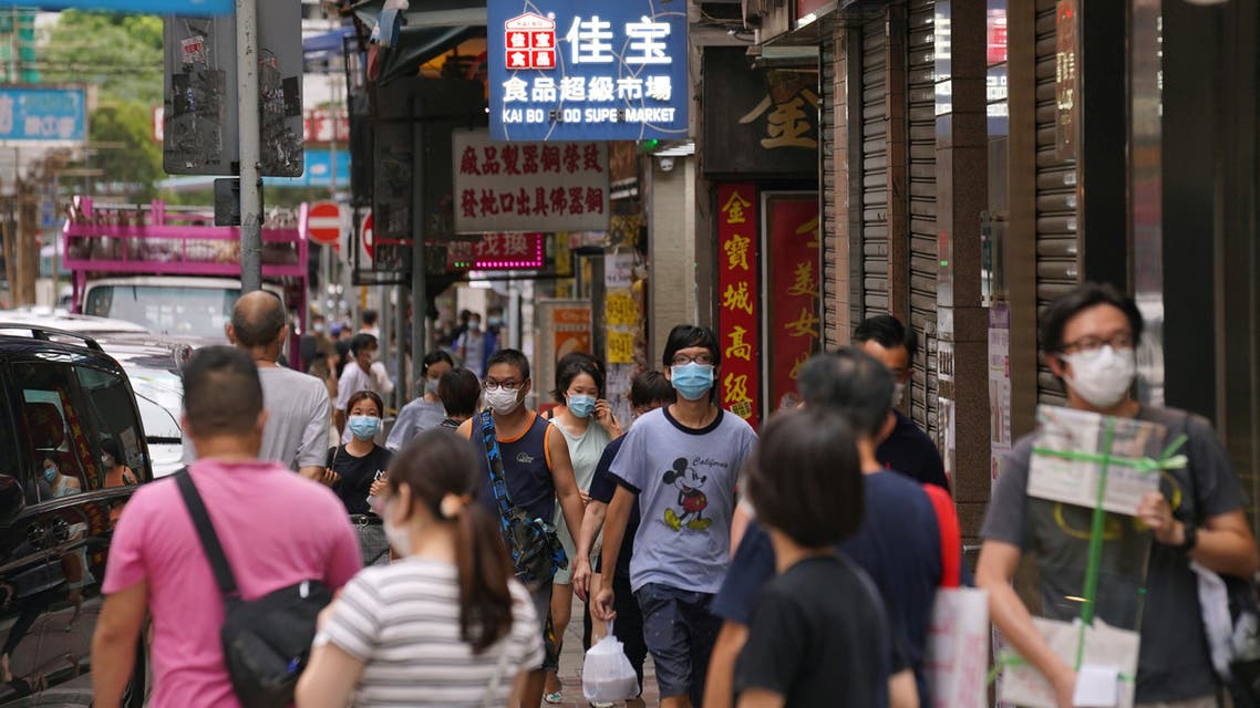 People wearing face masks walk on a street following the coronavirus disease (COVID-19) outbreak, in Hong Kong, China August 11, 2020. REUTERS/Lam Yik