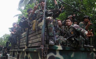 Soldiers gesture aboard a military truck as they are deployed to remote villages in Jolo, Sulu southern Philippines October 17, 2014 after hostages were captured by Abu Sayyaf militants. (Reuters)