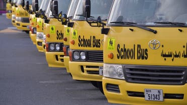 A picture taken on March 15, 2020 shows school buses parked outside a closed school in Dubai. (AFP)