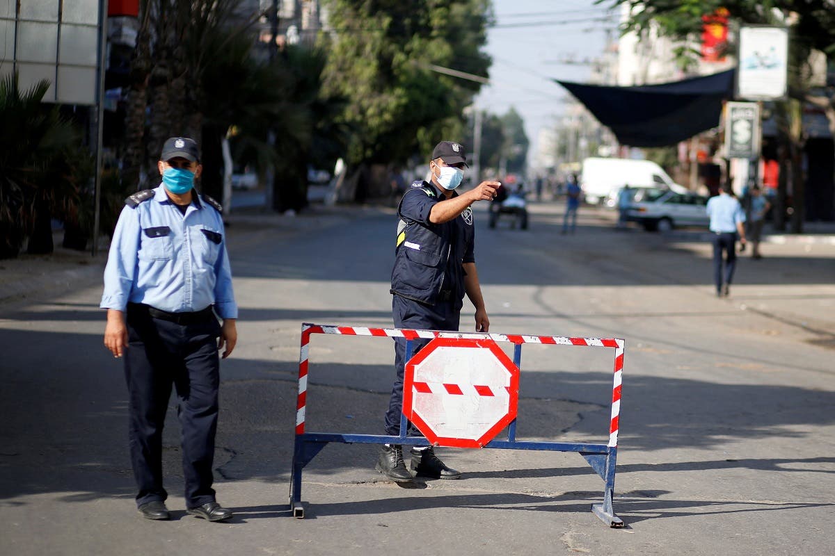 A Palestinian police officer gestures during a lockdown after Gaza reported its first cases of COVID-19 in the general population, in Gaza City August 25, 2020. (Reuters)