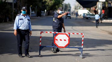 A Palestinian police officer gestures during a lockdown after Gaza reported its first cases of COVID-19 in the general population, in Gaza City August 25, 2020. (Reuters)
