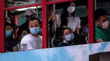 Commuters wear face masks as they travel on the top deck of a tram in Hong Kong. (File photo: AFP)