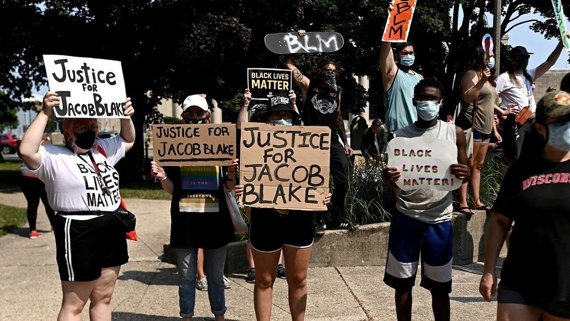 People protest after a Black man identified as Jacob Blake was shot several times by police in Kenosha. (Reuters)