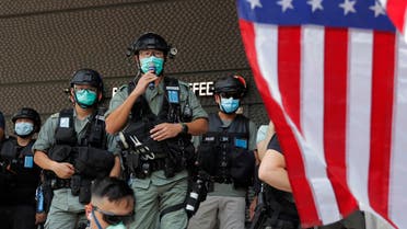 Riot police stand guard in front of an American flag near the U.S. Consulate in Hong Kong, Saturday, July 4, 2020 during the American Independence Day. (File photo: AP)