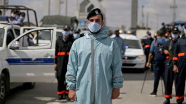 Members of Palestinian Hamas security forces wear protective gear as precaution against the coronavirus disease, at Rafah border crossing, Aug. 11, 2020. (Reuters)