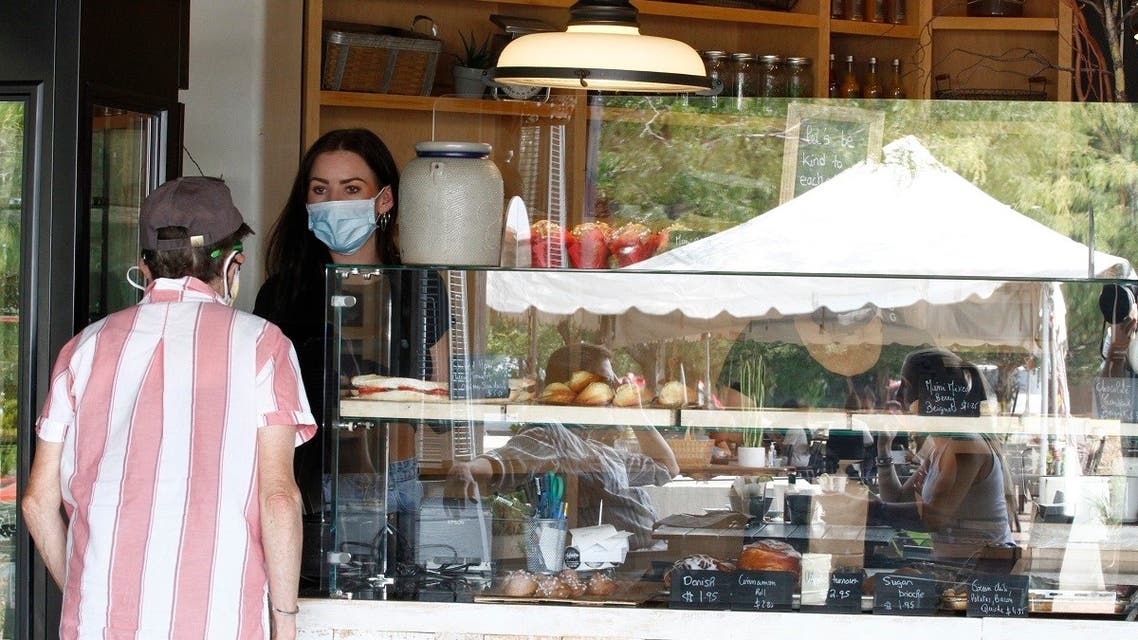 Marylou Ligier takes a to-go order to a patron at her family's restaurant and pastry shop in New Mexico. (File Photo: AP)