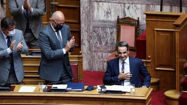 Greek Prime Minister Kyriakos Mitsotakis is applauded by his lawmakers and ministers after his speech during a parliamentary session on an accord which defines maritime boundaries with Egypt in the Mediterranean, at the parliament in Athens, Greece, August 26, 2020. (Reuters)