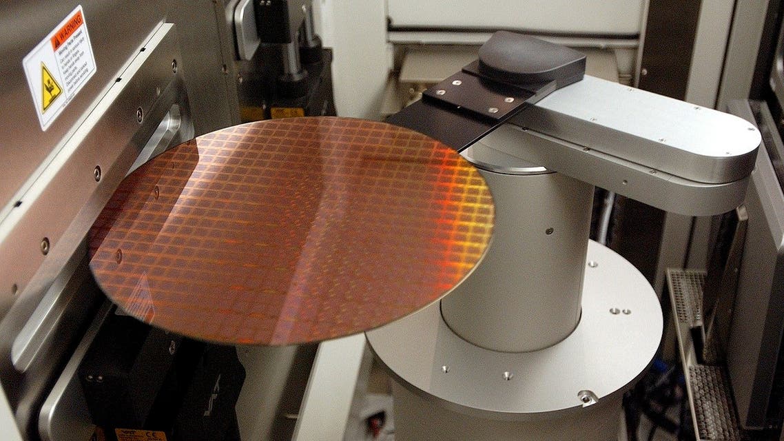 A wafer with hundreds of Power PC microprocessors is loaded into a machine to apply an oxide layer as part of the insulation process at the IBM 300 mm Manufacturing Plant in East Fishkill, New York. (File photo: Reuters)