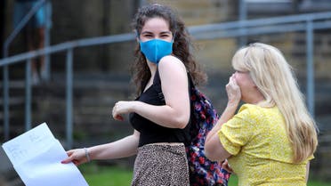 A sixth form student wearing a protective mask reacts after receiving her A-Level results at The Crossley Heath Grammar School, amid the spread of the coronavirus disease (COVID-19), in Halifax, Britain August 13, 2020. (Reuters)