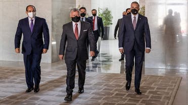 Jordanian King Abdullah II (C) arriving with Egyptian President Abdel Fattah al-Sisi (L) and Iraqi Prime Minister Mustafa al-Kadhemi (R) ahead of the summit in the capital Amman. (AFP)