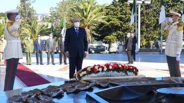 Algeria’s President Abdelmajid Tebboune observing a moment of silence during a ceremony to lay to rest the remains of 24 resistance fighters, returned from Paris after more than a century and a half, on the 58th anniversary of Algeria’s independence from France, in the capital Algiers on July 5, 2020. (AFP/ Ho/Algerian Presidency Press Service)