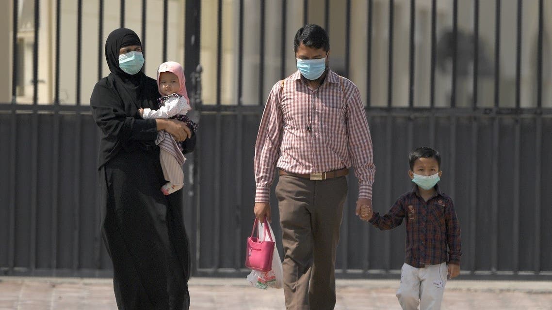 Parents wearing protective masks and their children leave a school they found closed due to the COVID-19 coronavirus, after arriving to register for the new academic year, in Sharjah. (File photo: Reuters)