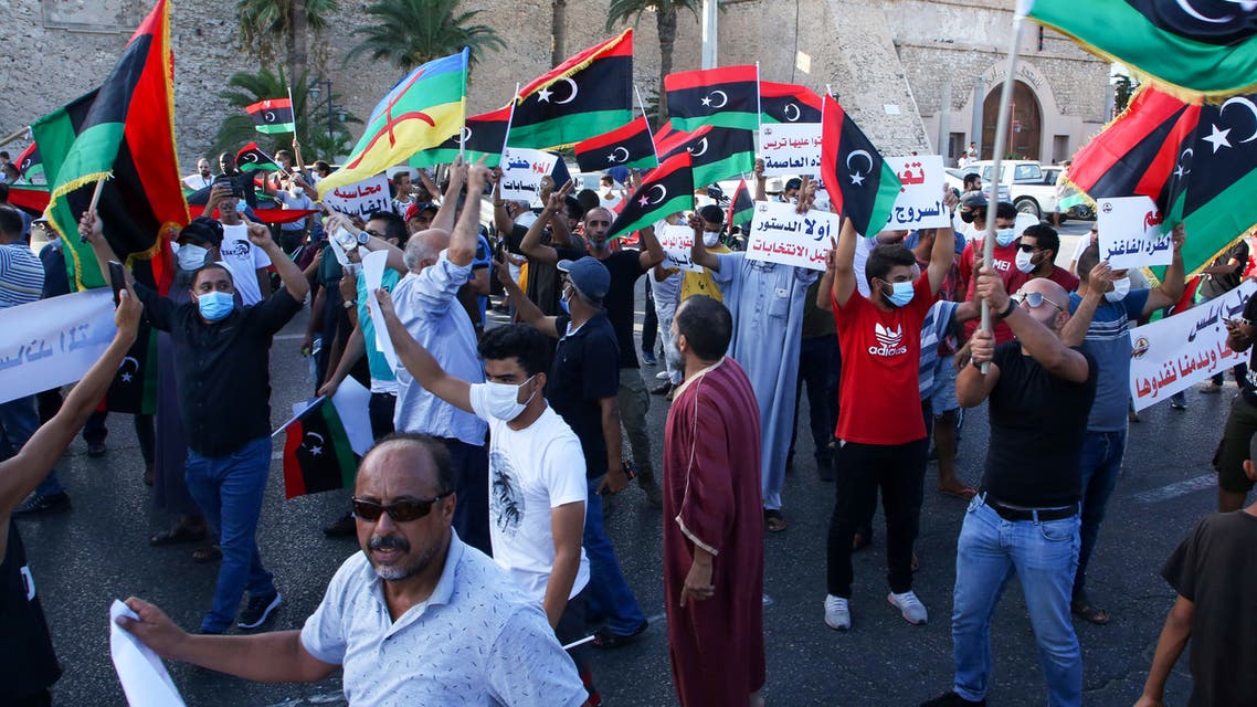 Libyans chant slogans during a demonstration due to poor public services at the Martyrs' Square at the centre of the GNA-held Libyan capital Tripoli on August 25, 2020. Angered by chronic water, power, and petrol shortages in a country with Africa's largest proven crude oil reserves, the mostly young people had marched through the city centre chanting slogans including No to corruption!