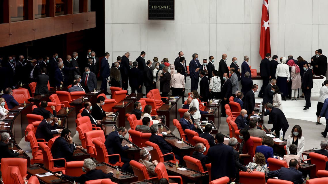 MPs wearing protective face masks queue to cast their vote to elect the new speaker of the Turkish Grand National Assembly on July 7, 2020 in Ankara. 