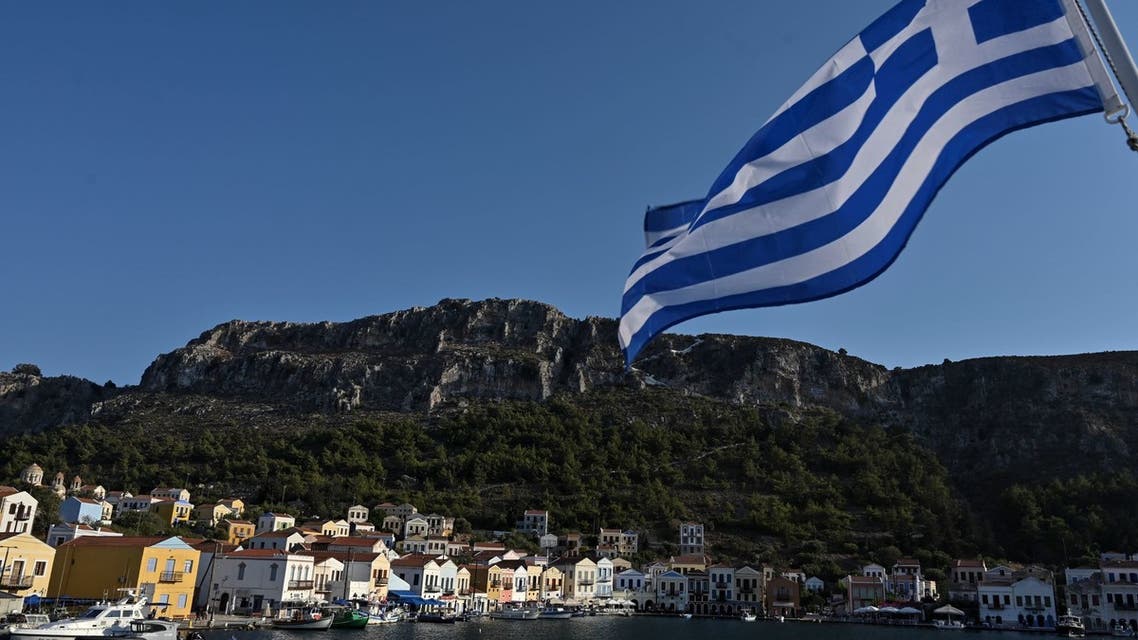 GREECE-TURKEY-DIPLOMACY-TOURISM Tourists walk past fishing boats along the harbour of the tiny Greek island of Kastellorizo, officially Megisti, the most south-eastern inhabited Greek island in the Dodecanese, situated two kilometers off the south coast of Turkey on August 28, 2020.