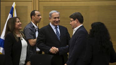 Israel's Prime Minister Benjamin Netanyahu (C) shakes hands with lawmaker Ofir Akunis (R) during a Likud party meeting at parliament in Jerusalem May 11, 2015. (Reuters)