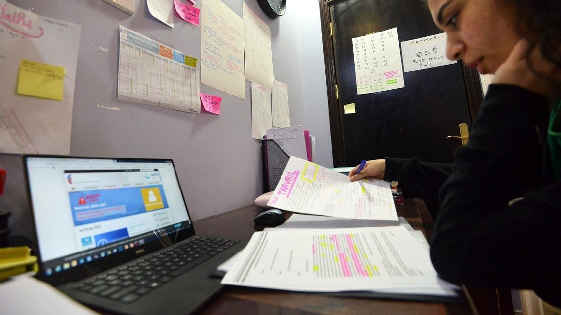 Foreign student Shayma, attending the French International Lycée in Riyadh, studies at home on March 23, 2020. (AFP)