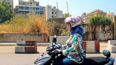Carine Karazi drives a motorbike used by her and her mother's women-only taxi service. (Supplied)