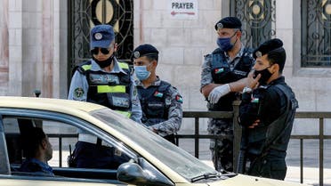 Policemen stop a vehicle outside the Grand Husseini Mosque while enforcing a curfew due to the COVID-19 coronavirus pandemic in Jordan's capital Amman on August 28, 2020. (AFP)