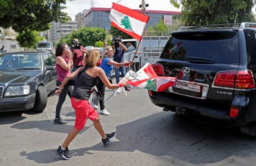 000_1WH0KQLebanese anti-government protesters attack a vehicle belonging to a member of the parliament upon his arrival to the parliamentary session at the UNESCO Palace in Beirut, on August 13, 2020. (AFP)