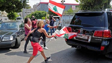 000_1WH0KQLebanese anti-government protesters attack a vehicle belonging to a member of the parliament upon his arrival to the parliamentary session at the UNESCO Palace in Beirut, on August 13, 2020. (AFP)