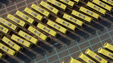 A drone image taken on April 27, 2020, shows school buses parked in a lot in the Emirate of Dubai, during the coronavirus pandemic. (File photo: AFP)
