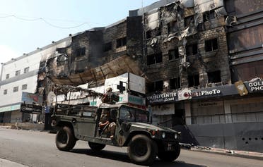 Lebanese army soldiers patrol near burnt shops in the aftermath of clashes in Khaldeh, Lebanon August 28, 2020. (Reuters)