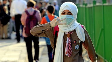 A student attends the first day of school while wearing a protective mask and gloves in the Jordanian capital Amman amid the ongoing COVID-19 pandemic, on September 1, 2020. (AFP)