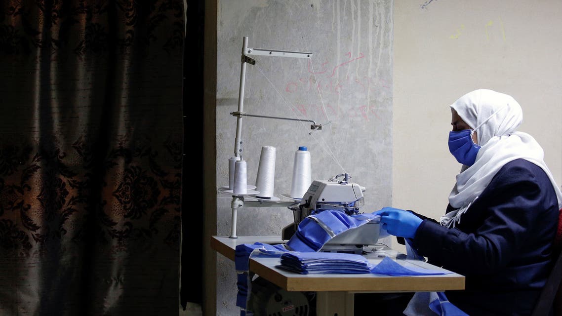 A worker makes face masks in order to provide help to healthcare workers and hospitals to face the spread of coronavirus disease (COVID-19) at an atelier in Damascus, Syria April 16, 2020. Picture taken April 16, 2020. REUTERS/Omar Sanadiki