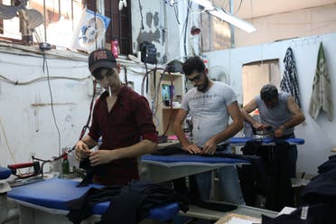 Syrian refugee men work at a textile workshop as day laborer in Istanbul, Turkey, June 20, 2019. (Reuters)