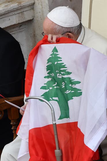 Pope Francis holds Lebanon's flag as he makes a statement about the situation in the country, during a limited public audience at the San Damaso courtyard in The Vatican, Sept. 2, 2020. (AFP)