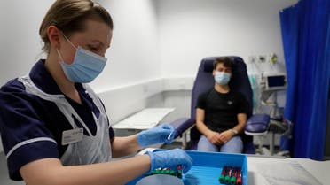 Clinical Research Nurse Aneta Gupta labels blood samples from volunteer Yash during the Imperial College vaccine trial, at a clinic in London, Wednesday, Aug. 5, 2020.  (File photo: AP)