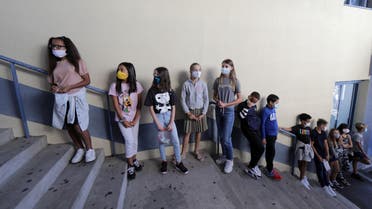 Secondary school students, wearing protective face masks, line-up to enter in the school canteen room at the College Henri Matisse school during its reopening in Nice as French children return to their schools after the summer break. September 1, 2020. (Reuters)
