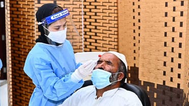 A female nurse conducts a COVID-19 test on a man in Fujairah, September 3, 2020. (WAM)