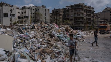 People sort through glass and rubble from the August 4 explosion on 26 August 2020 in Beirut, Lebanon. (Reuters)