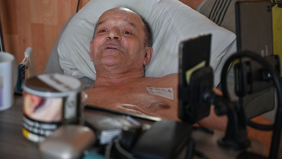 Alain Cocq, suffering from an orphan desease of the blood, rests on his medical bed on August 12, 2020 in his flat in Dijon, northeastern France. (AFP)