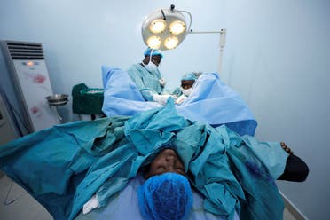 As a pediatric surgeon Hennessey has worn an identical surgical facemask at work for the past 20 years, but says he wishes the development of transparent masks had happened sooner. (Reuters)