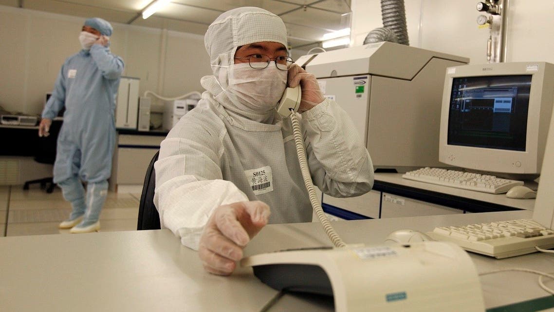 Employees work at a production line in the clean room of Semiconductor Manufacturing International Corporation (SMIC) in Shanghai. SMIC is the biggest semiconductor manufacturer in China. (Reuters)