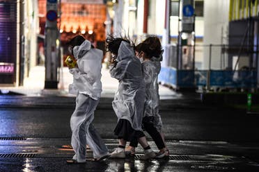 Women walk in heavy rain as Typhoon Haishen hits Kagoshima, Kagoshima prefecture on September 6, 2020. (AFP)